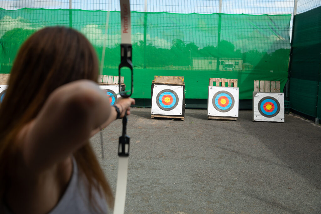 An archer taking aim at outdoor targets at Moira Lakes