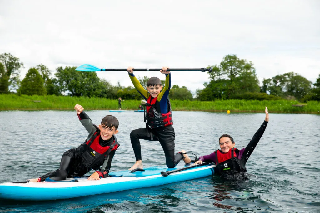 Young people enjoying paddleboarding on the lake at Moira Lakes