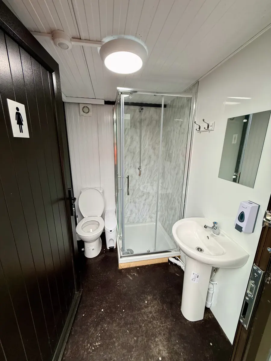 Campsite shower room with toilet and washbasin