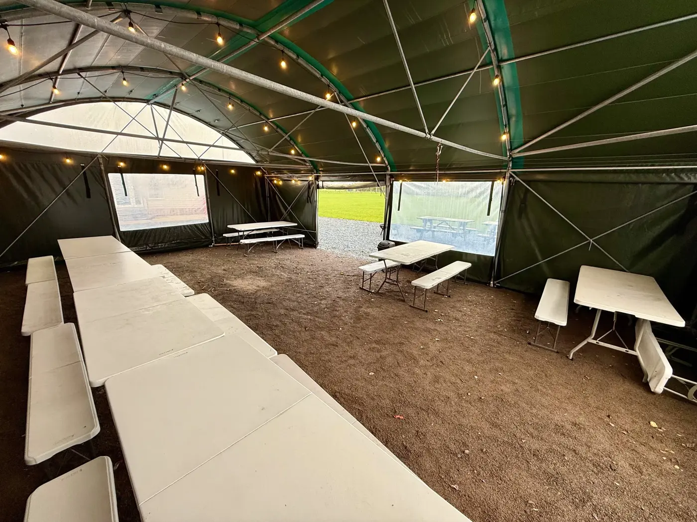 Tables and benches inside the covered campsite shelter